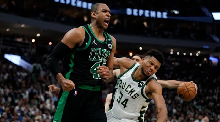 Boston Celtics’ Al Horford reacts in front of Milwaukee Bucks’ Giannis Antetokounmpo during the second half of Game 4 of an NBA basketball Eastern Conference semifinals playoff series Monday, May 9, 2022, in Milwaukee. The Celtics won 116-108 to tie the series 2-2.